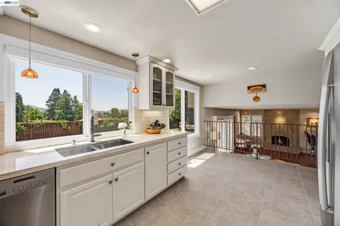 a kitchen with a sink stove and window