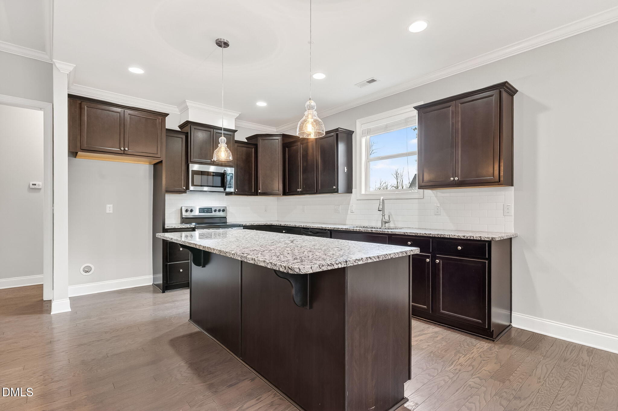 5441 Fantasy Moth Drive Garner, NC 27529 - Photo 12 of 55 a kitchen with stainless steel appliances granite countertop a sink stove and refrigerator