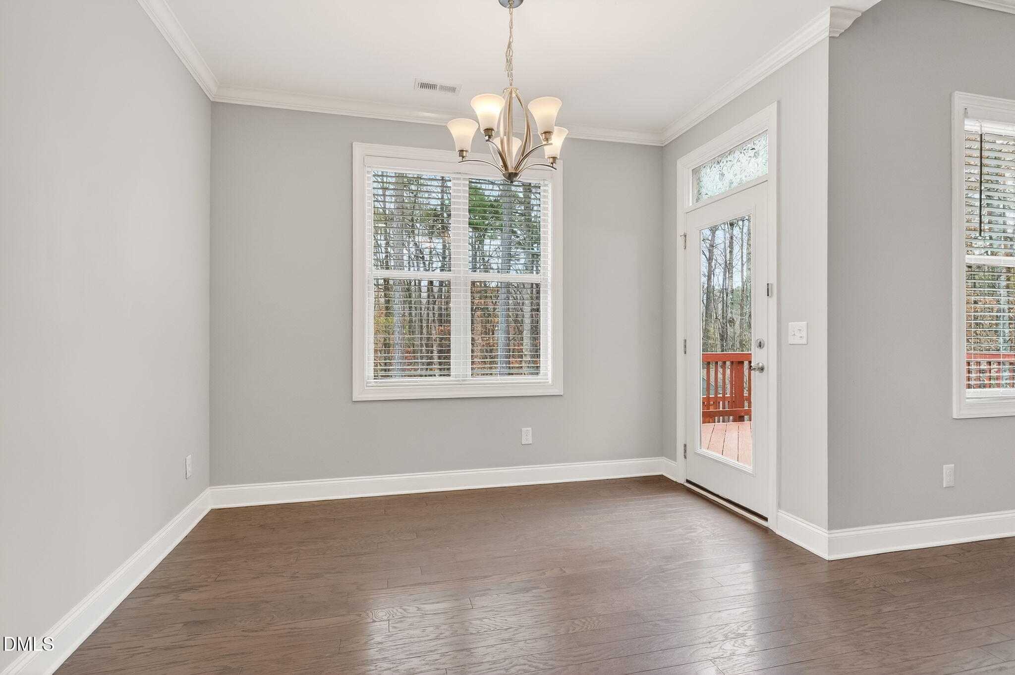 5441 Fantasy Moth Drive Garner, NC 27529 - Photo 15 of 55 an empty room with wooden floor and windows