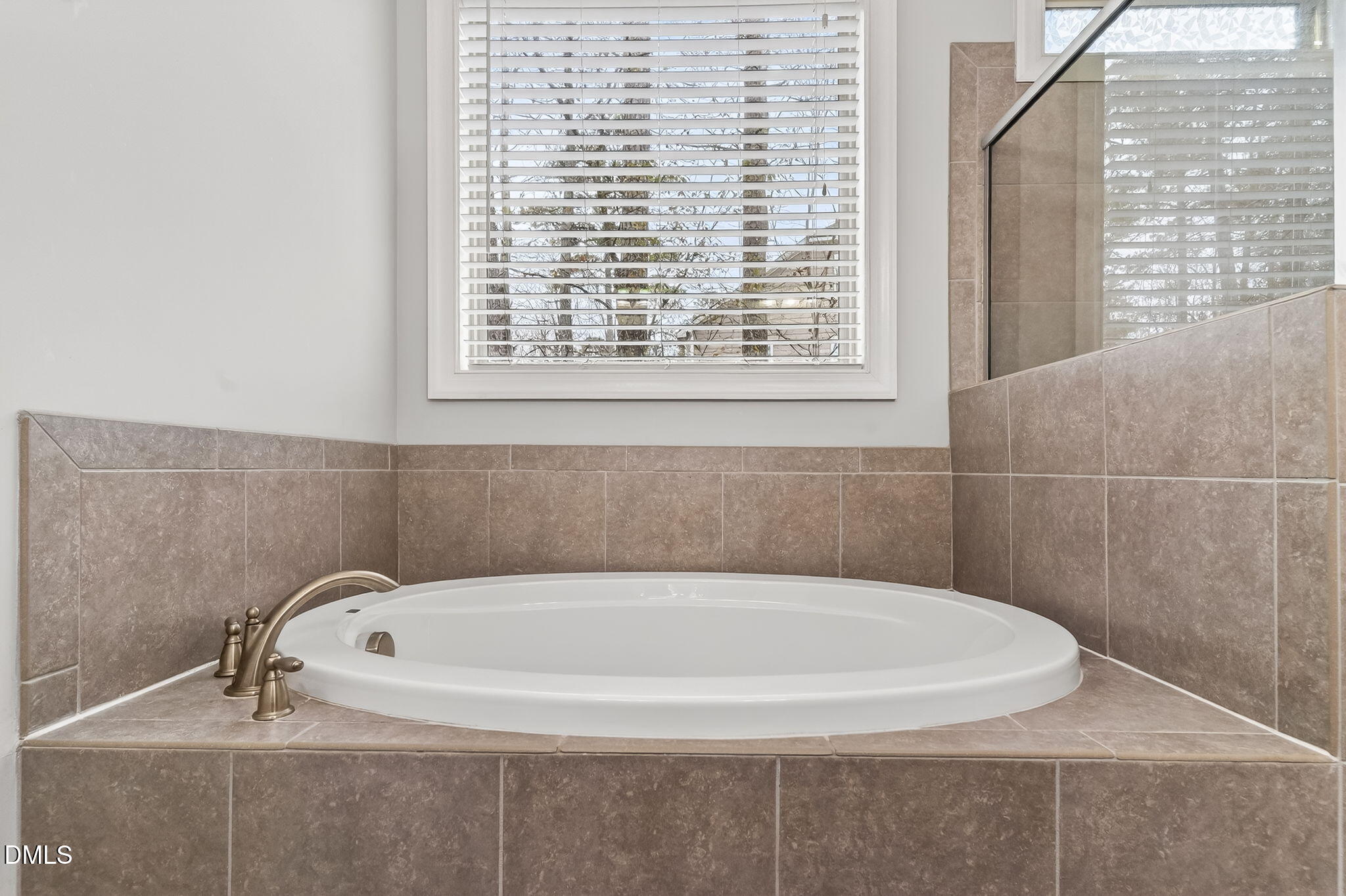 5441 Fantasy Moth Drive Garner, NC 27529 - Photo 21 of 55 a white bath tub sitting in a bathroom next to a window