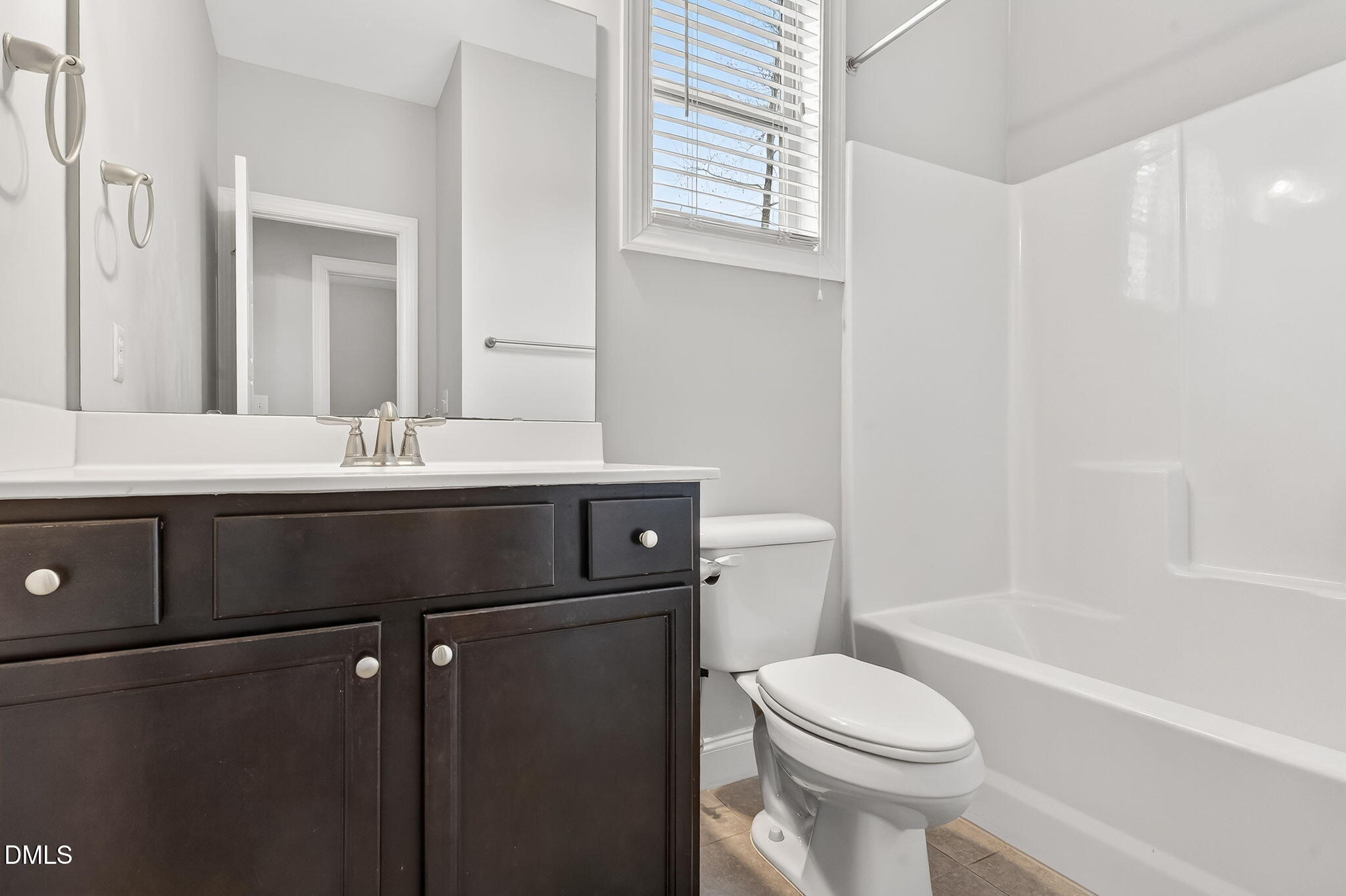 5441 Fantasy Moth Drive Garner, NC 27529 - Photo 31 of 55 a bathroom with a sink a toilet and a mirror