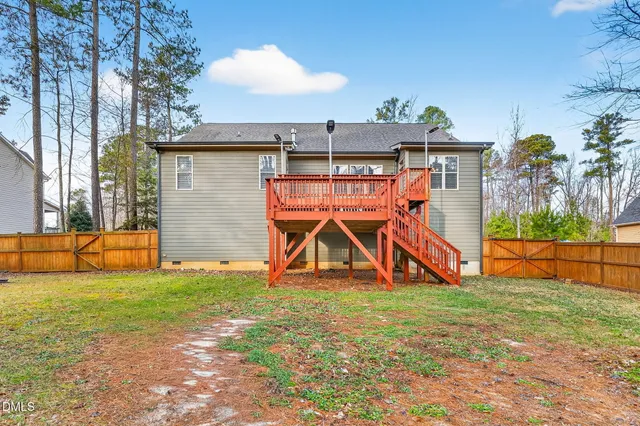 an aerial view of a house with a yard basket ball court and outdoor seating