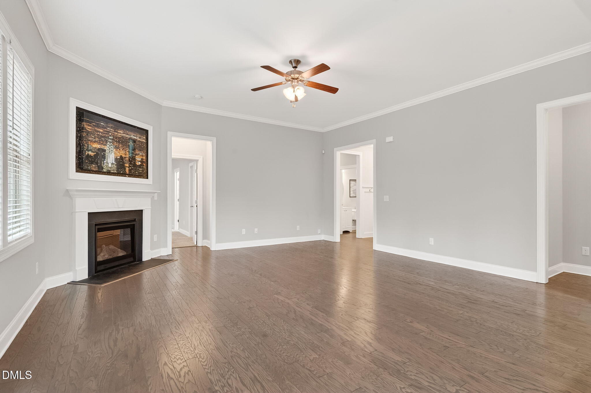 5441 Fantasy Moth Drive Garner, NC 27529 - Photo 9 of 55 a view of a livingroom with a fireplace a ceiling fan and wooden floor