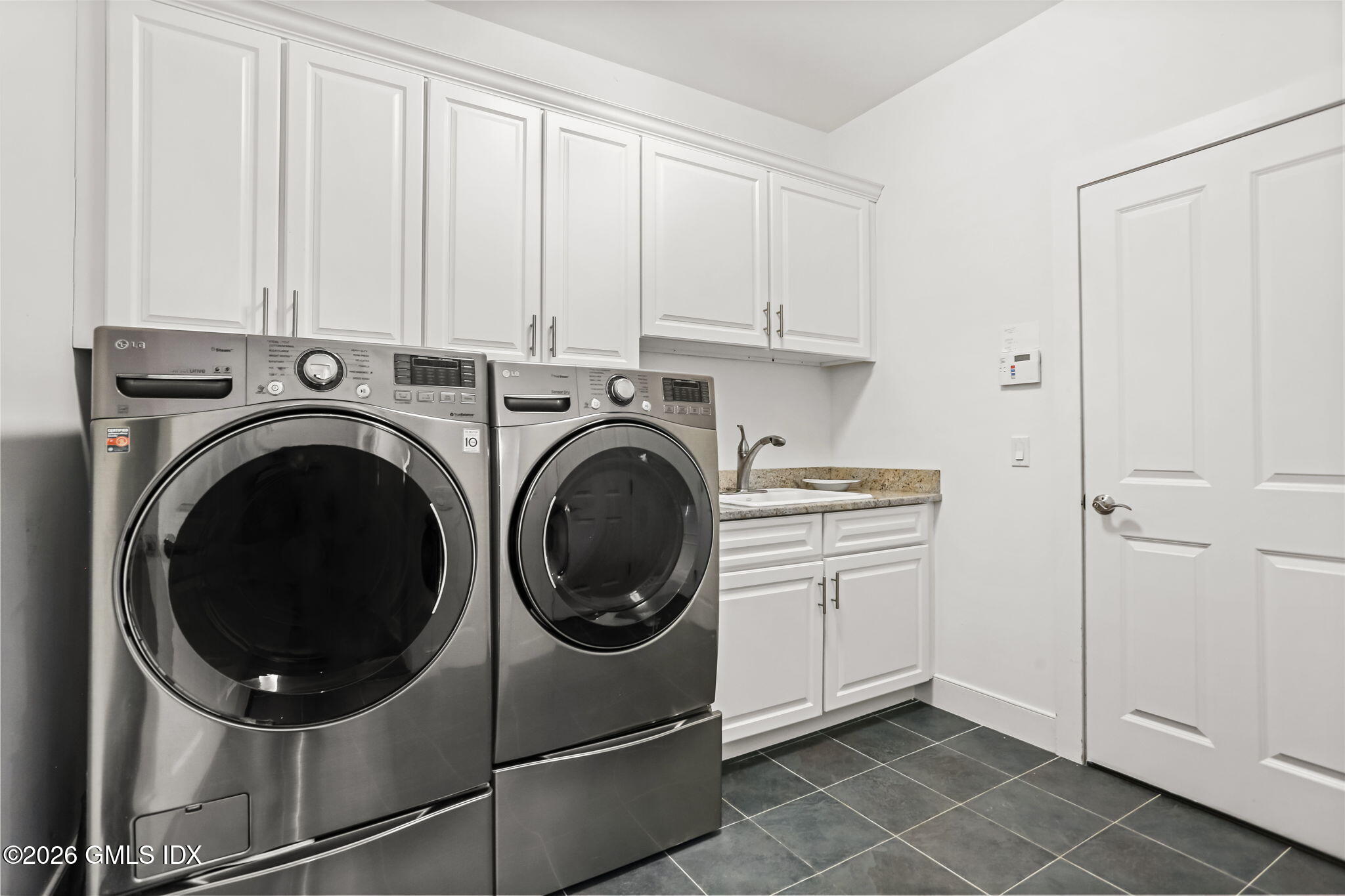 77 Havemeyer Lane, Unit 58 Stamford, CT 06902 - Photo 16 of 40 a view of a storage & utility room with washer and dryer