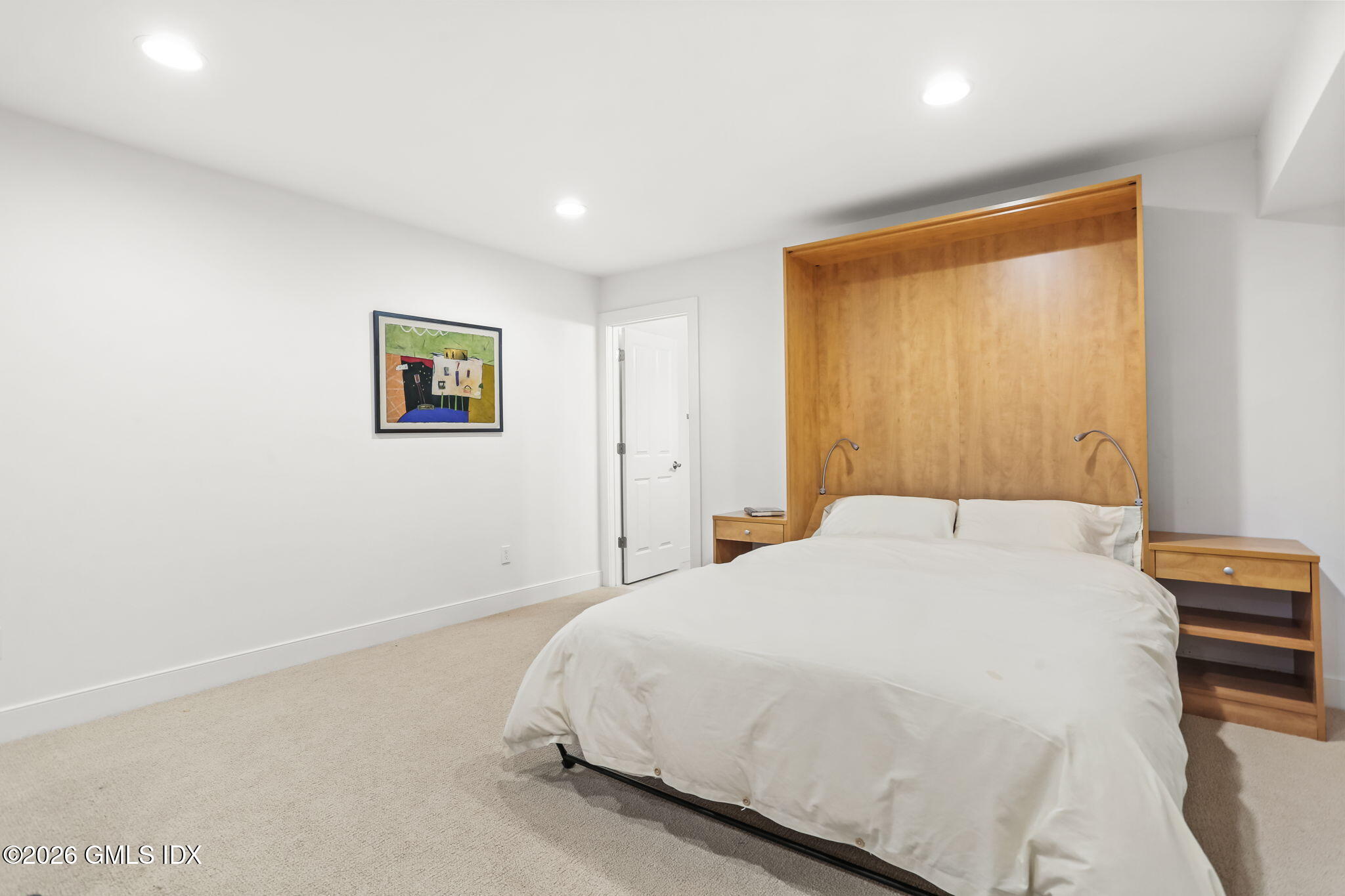 77 Havemeyer Lane, Unit 58 Stamford, CT 06902 - Photo 27 of 40 a bedroom with a bed and a painting on the wall