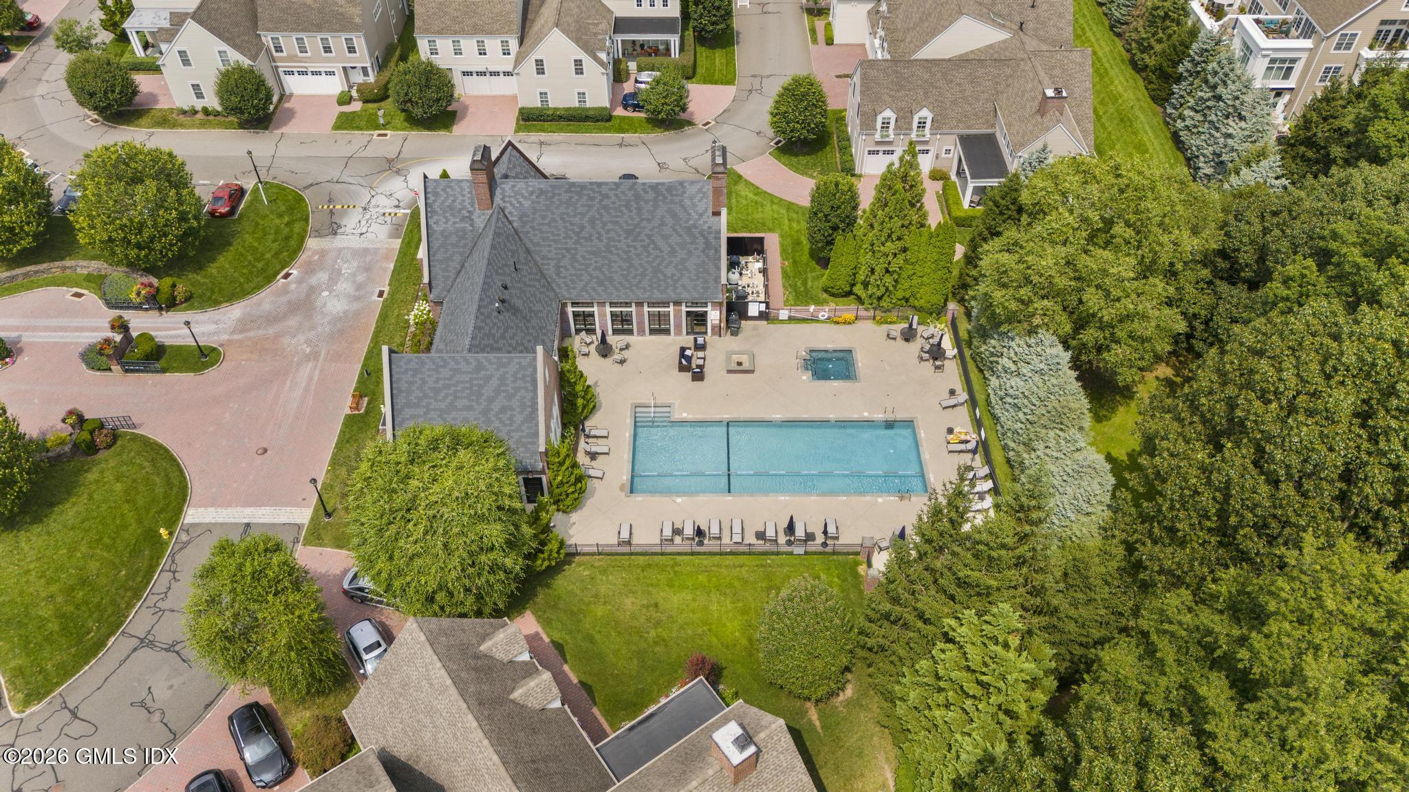 77 Havemeyer Lane, Unit 58 Stamford, CT 06902 - Photo 36 of 40 an aerial view of a house with a garden and swimming pool