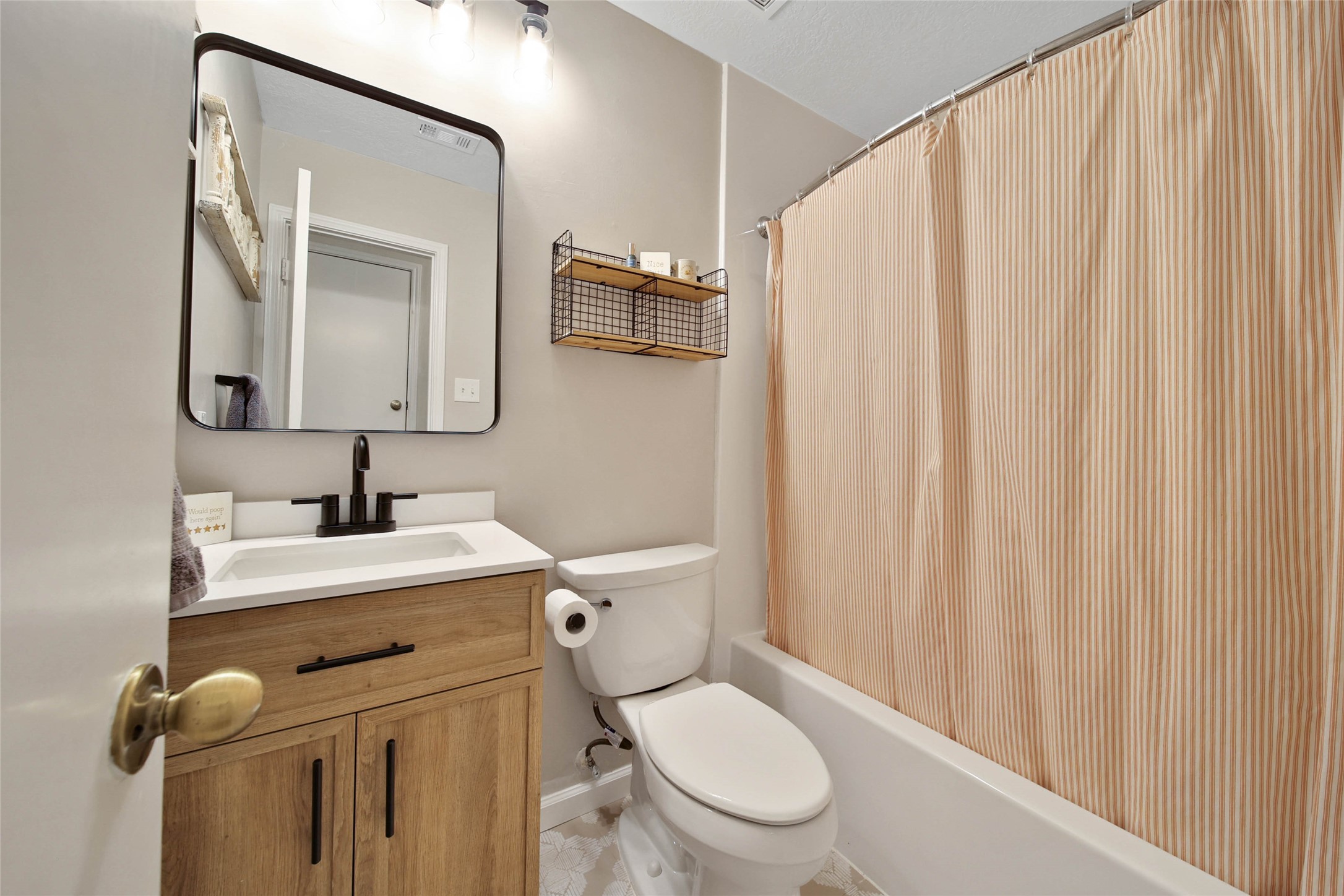 4843 Drew Forest Lane Humble, TX 77346 - Photo 17 of 21 The small but functional secondary bathroom was recently given a fresh update with vanity, mirror, fixtures, and flooring!