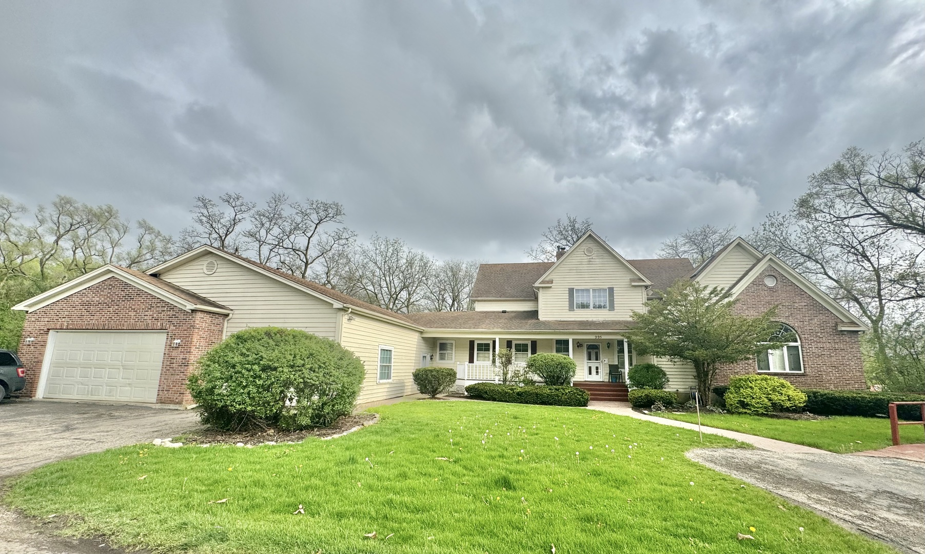 a front view of a house with a garden