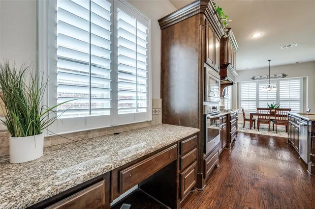 a kitchen with sink stove and wooden floor