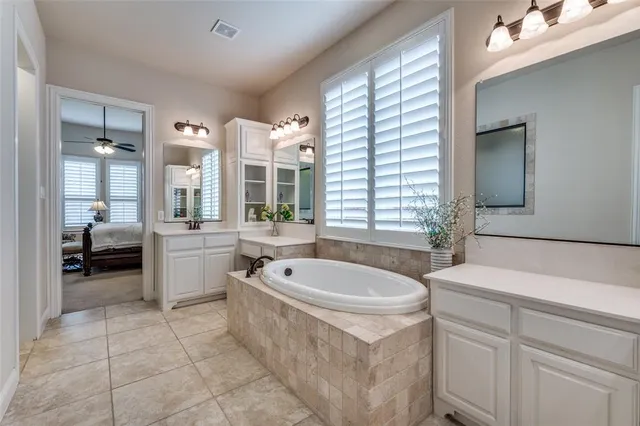 a spacious bathroom with a tub shower and sink