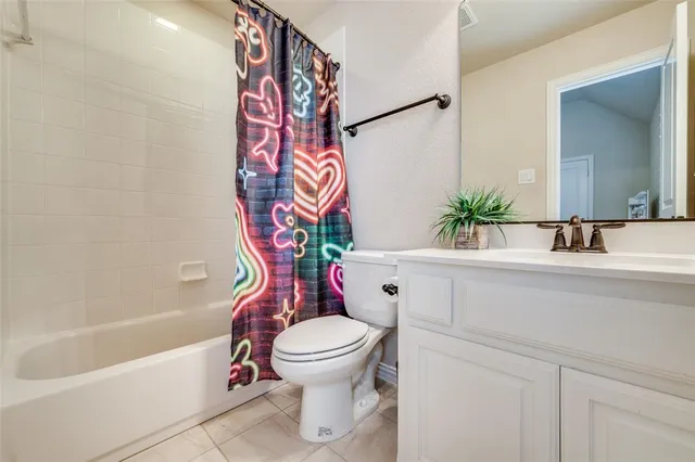 a bedroom with a bed a chandelier and a window