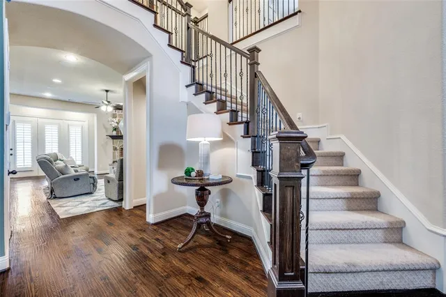 a view of entryway and hall with wooden floor