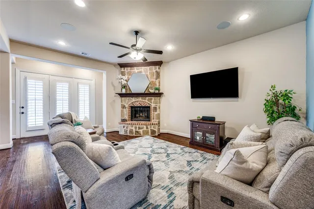 a living room with furniture a fireplace and a flat screen tv