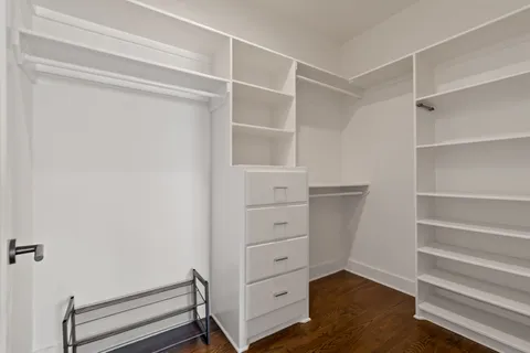 a view of walk in closet with empty racks