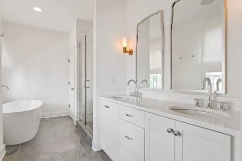 a bathroom with a double vanity sink and a mirror