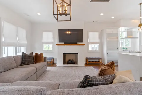 a living room with furniture a fireplace and a flat screen tv