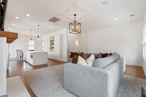 a living room with furniture and a chandelier