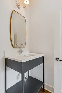 a bathroom with a sink a vanity and a mirror