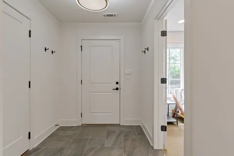 a view of an entryway with wooden floor