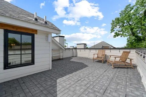a backyard of a house with yard and outdoor seating