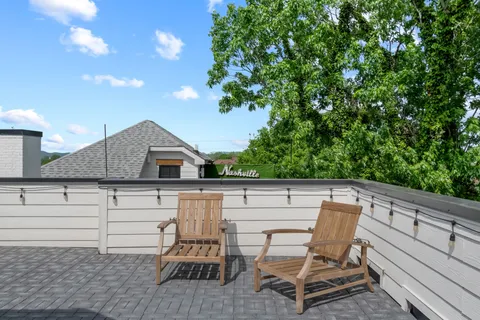 a roof deck with table and chairs