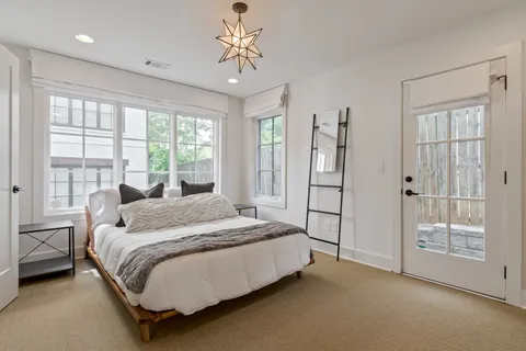 a spacious bedroom with a bed and a window