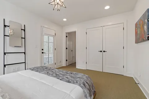 a bedroom with a bed and a chandelier