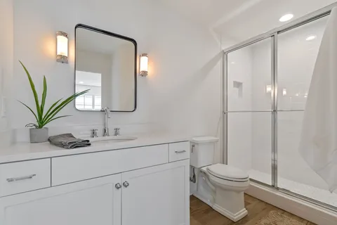 a bathroom with a toilet sink and shower
