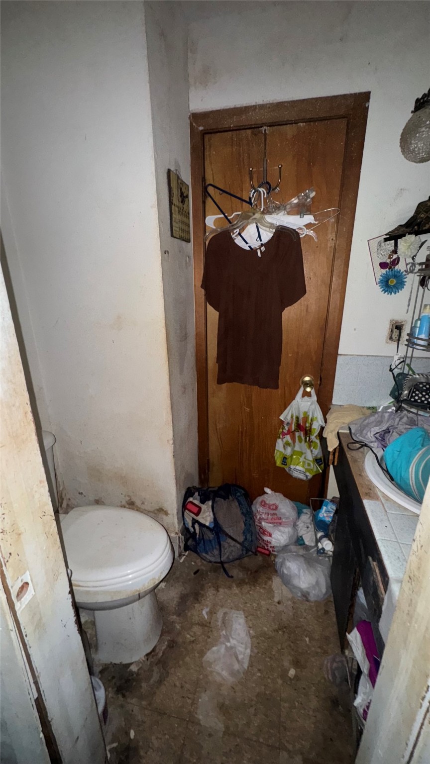 1111 Avenue B Sweeny, TX 77480 - Photo 13 of 17 a bathroom with a toilet a sink and a mirror