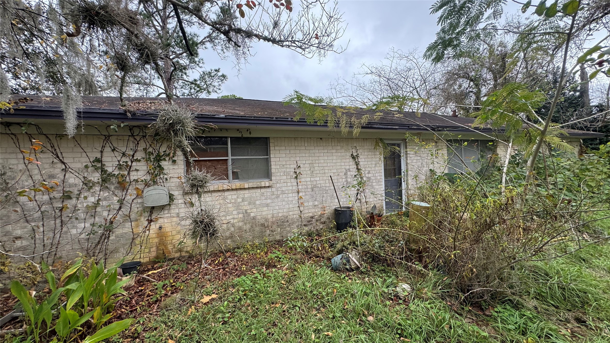 1111 Avenue B Sweeny, TX 77480 - Photo 17 of 17 a backyard of a house with table and chairs under an umbrella