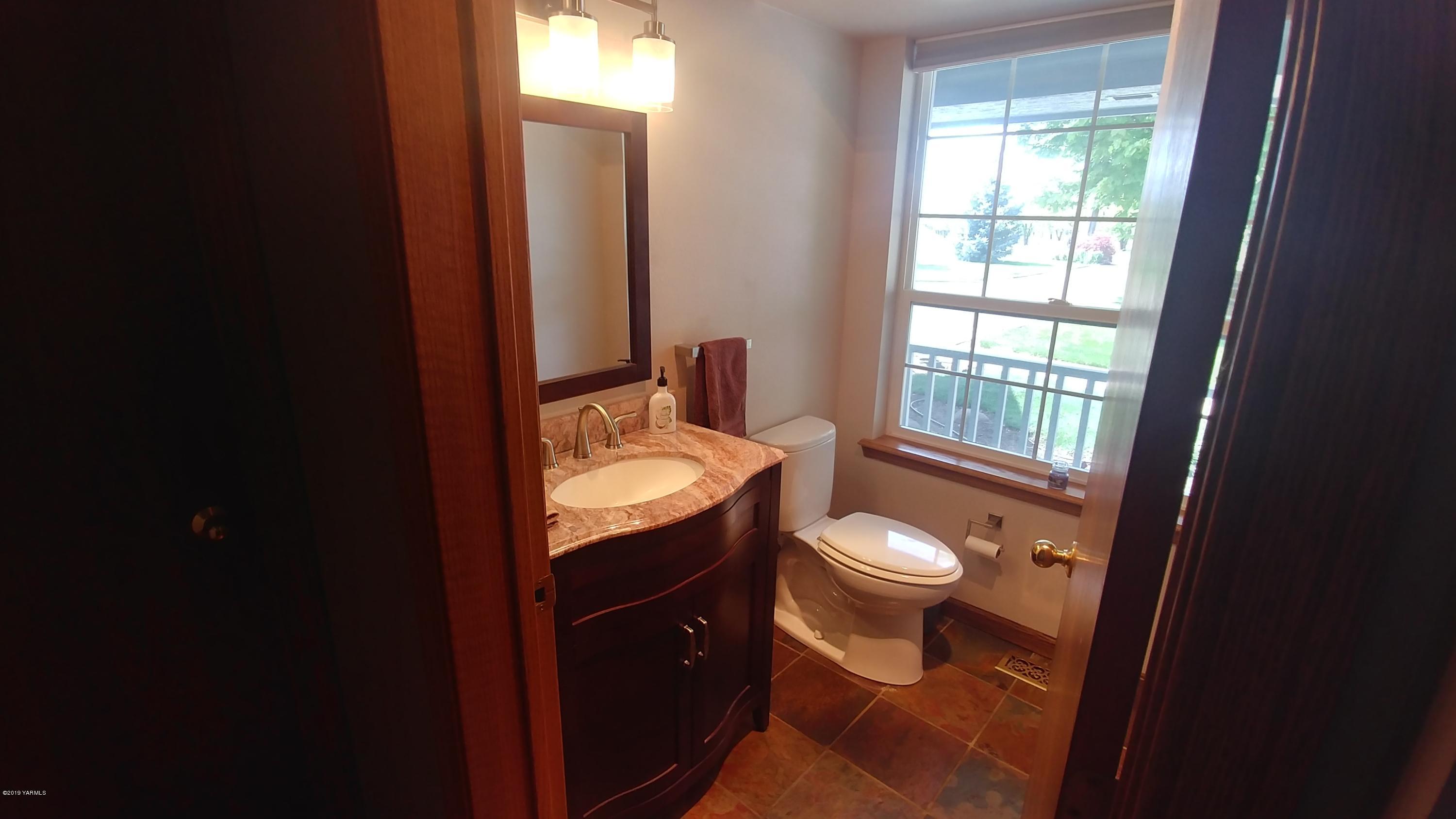 2001 Moore Road Yakima, WA 98908 - Photo 10 of 36 a bathroom with a granite countertop toilet and a sink
