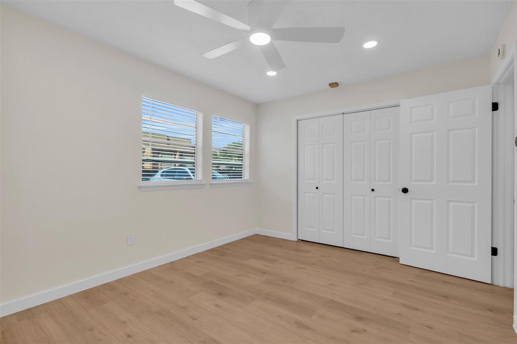 6077 Milton Street, Unit 137 Dallas, TX 75206 - Photo 6 of 15 a view of empty room with wooden floor and fan