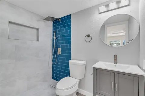 a white toilet sitting next to a bathroom sink