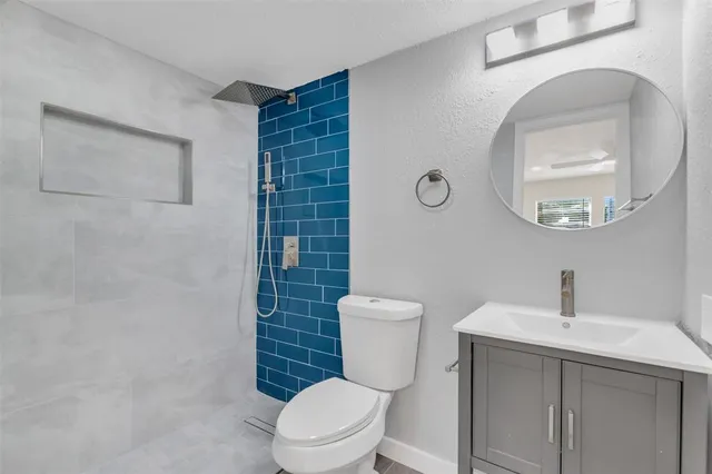 a white toilet sitting next to a bathroom sink