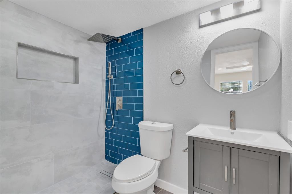 6077 Milton Street, Unit 137 Dallas, TX 75206 - Photo 10 of 15 a white toilet sitting next to a bathroom sink