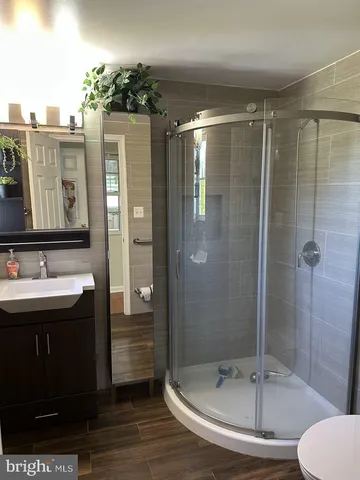 a bathroom with a shower and a sink