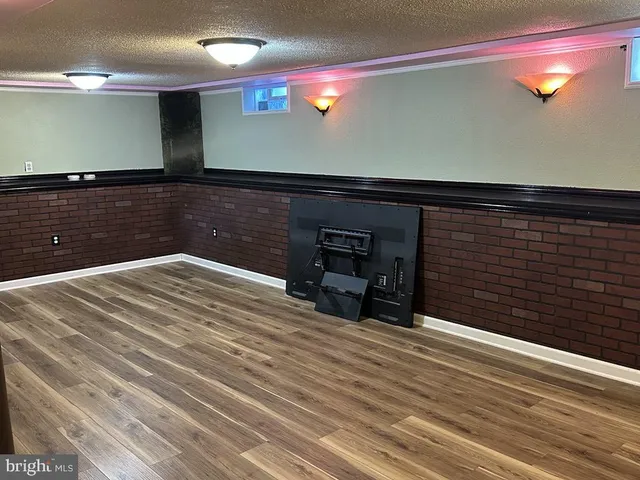 a room with a bed and a television