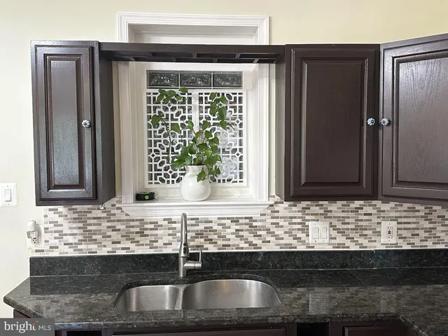 a kitchen with granite countertop a sink and a window