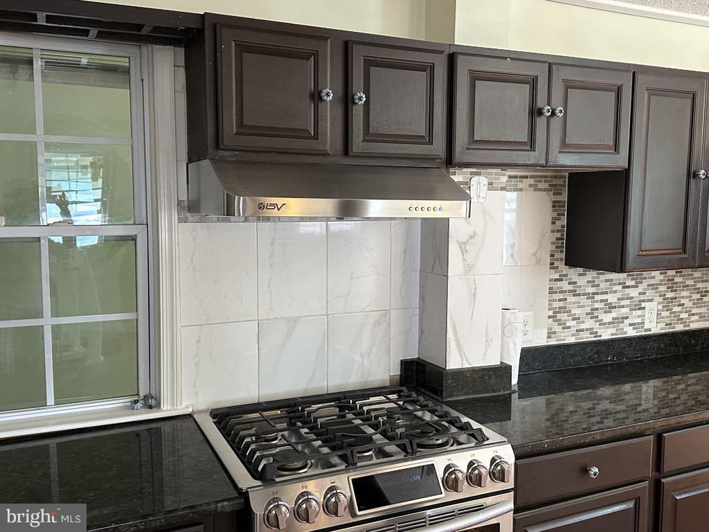 308 Pinewood Road Baltimore, MD 21222 - Photo 4 of 21 a kitchen with granite countertop a stove and a cabinets