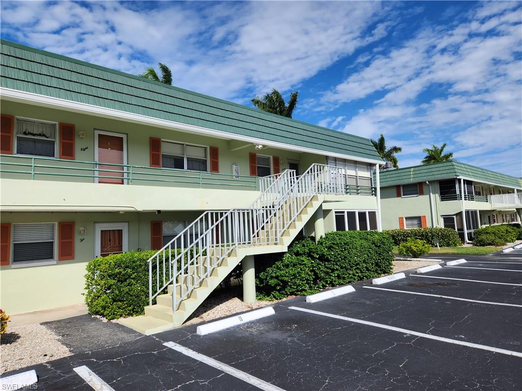 300 Valley Stream Drive, Unit D5 Naples, FL 34113 - Photo 1 of 12 a front view of a house with a yard