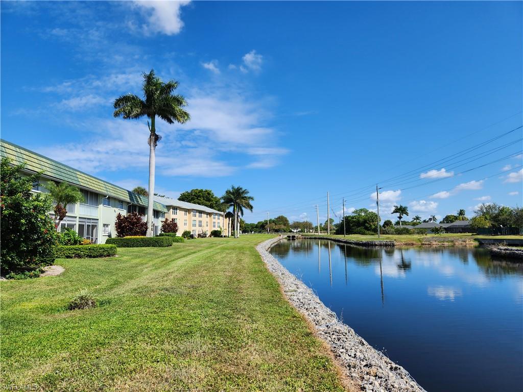 300 Valley Stream Drive, Unit D5 Naples, FL 34113 - Photo 11 of 12 a swimming pool with outdoor seating and yard
