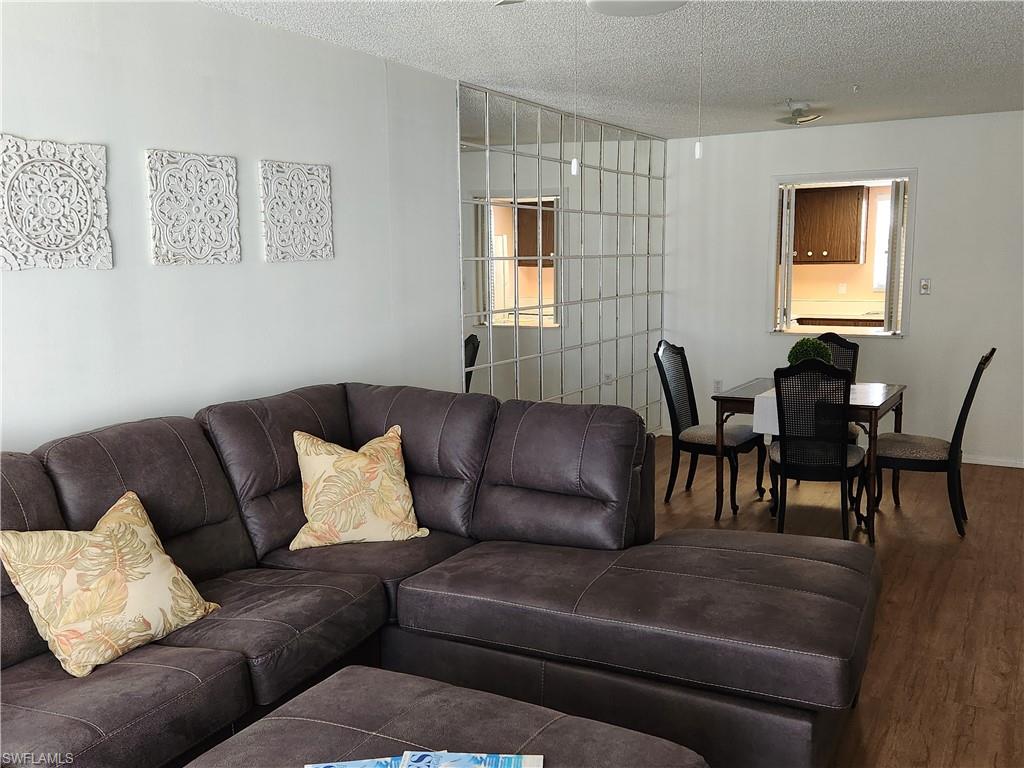 300 Valley Stream Drive, Unit D5 Naples, FL 34113 - Photo 3 of 12 a living room with furniture and a flat screen tv