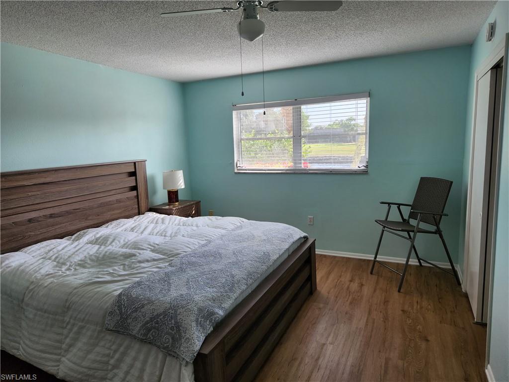 300 Valley Stream Drive, Unit D5 Naples, FL 34113 - Photo 4 of 12 a bed sitting in a bedroom next to a window