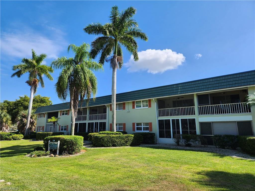 300 Valley Stream Drive, Unit D5 Naples, FL 34113 - Photo 8 of 12 a front view of a house with garden and porch