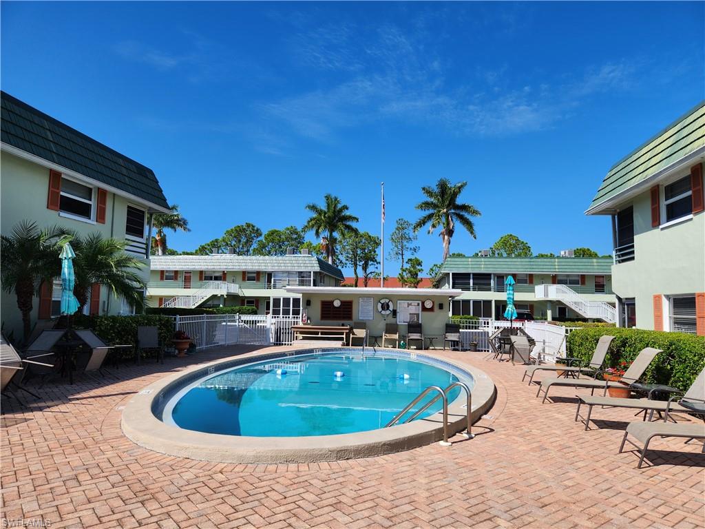 300 Valley Stream Drive, Unit D5 Naples, FL 34113 - Photo 9 of 12 a view of a swimming pool with a patio