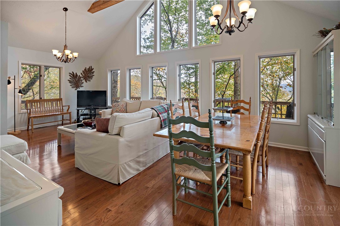 265 Leatherwood Road Banner Elk, NC 28604 - Photo 13 of 42 a view of a dining room with furniture wooden floor and chandelier