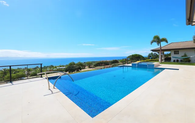 a view of swimming pool with outdoor seating and city view