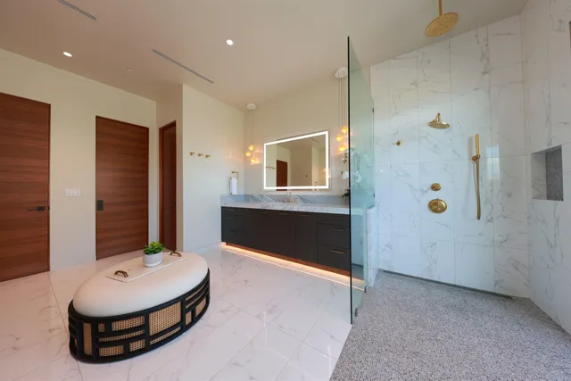 a bathroom with a sink a toilet and shower