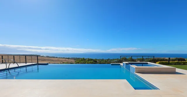 a view of swimming pool with lake view and mountain in the back