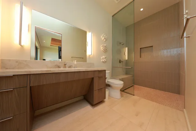 a bathroom with a double vanity sink toilet mirror and shower